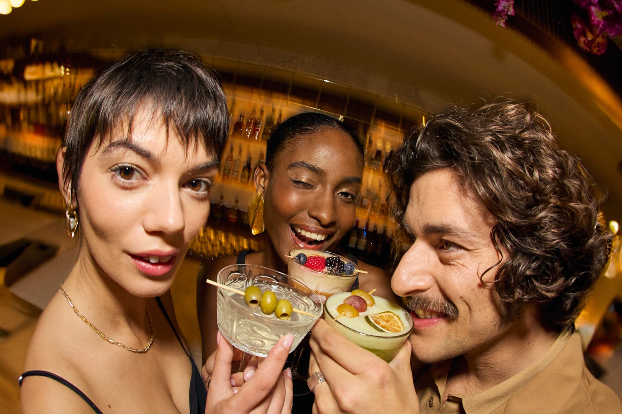 a group of people holding drinks