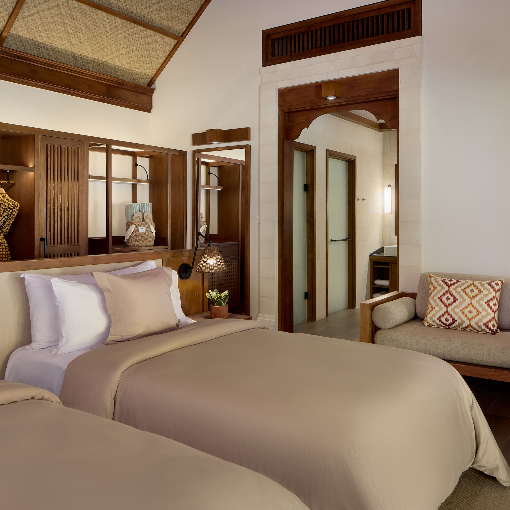 a room with two beds and a couch