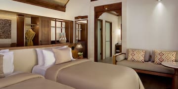 a room with two beds and a couch