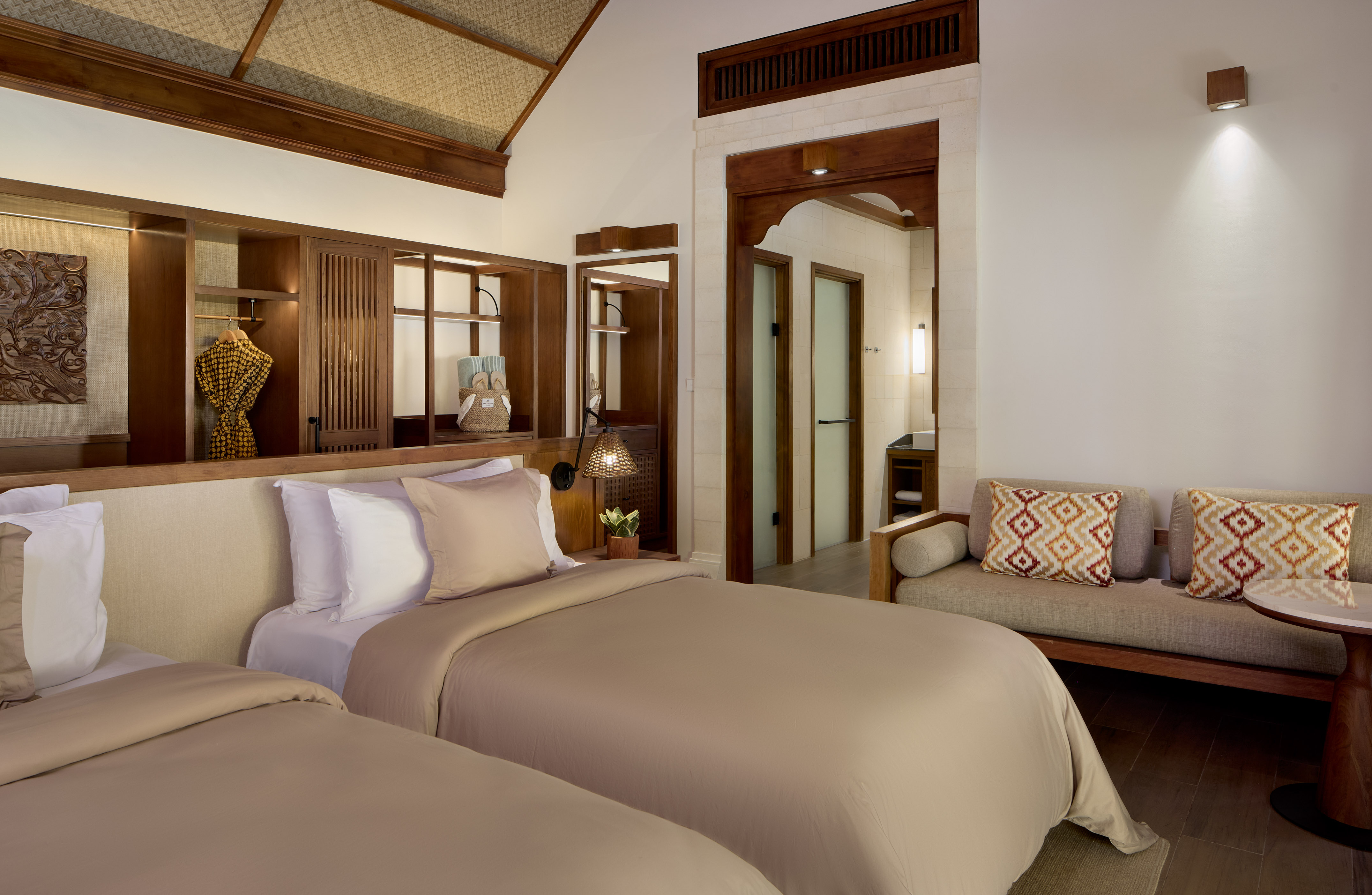 a room with two beds and a couch