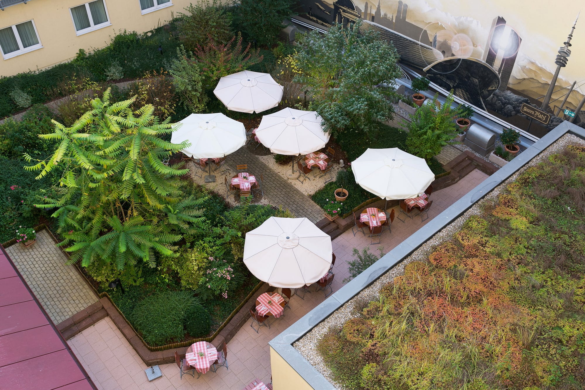 a patio area with tables and umbrellas