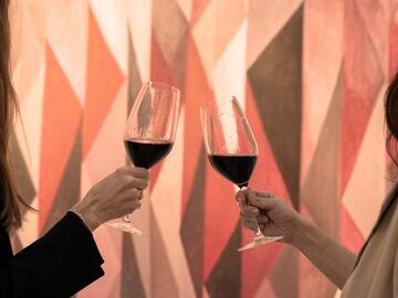 two women holding wine glasses