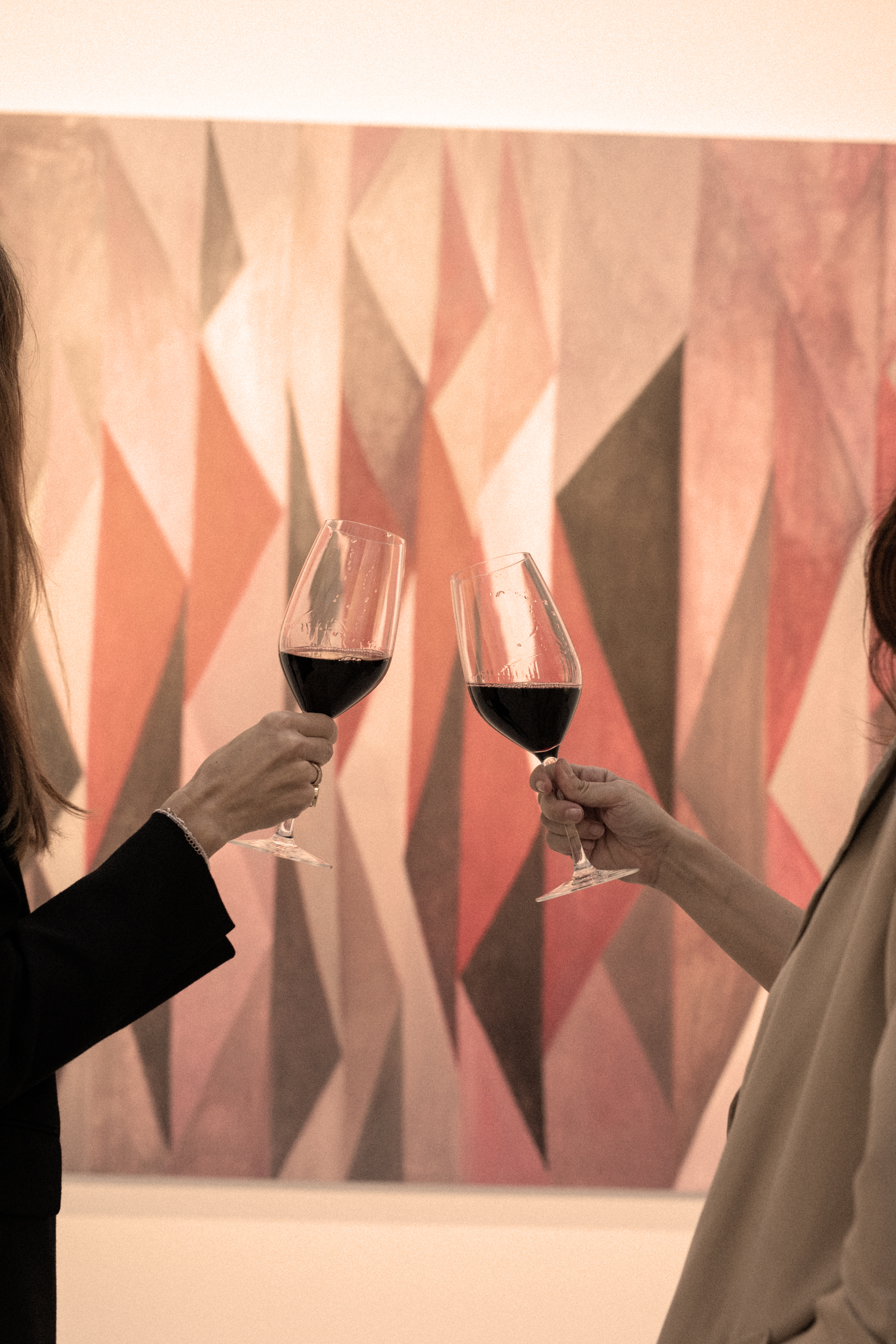 two women holding wine glasses