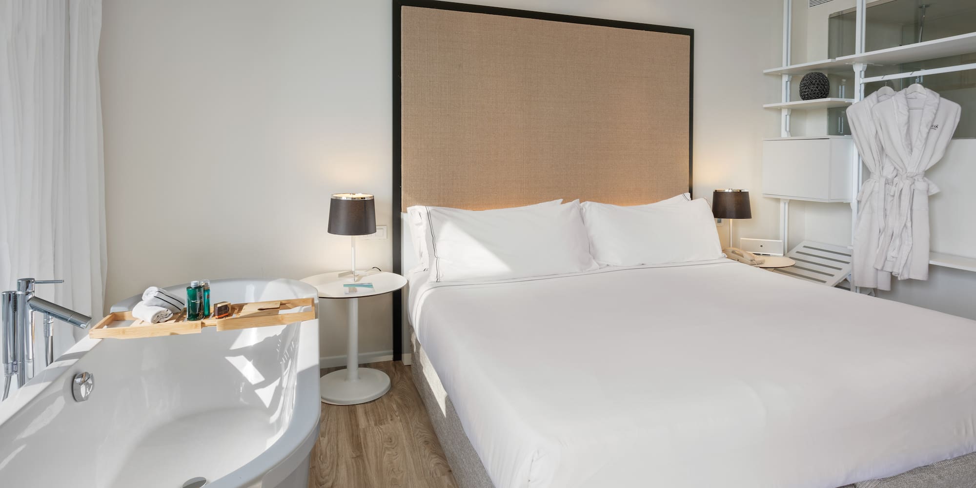 a bed with a bathtub and a lamp