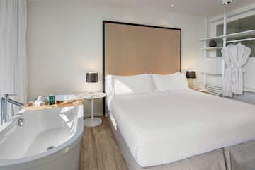 a bed with a bathtub and a lamp