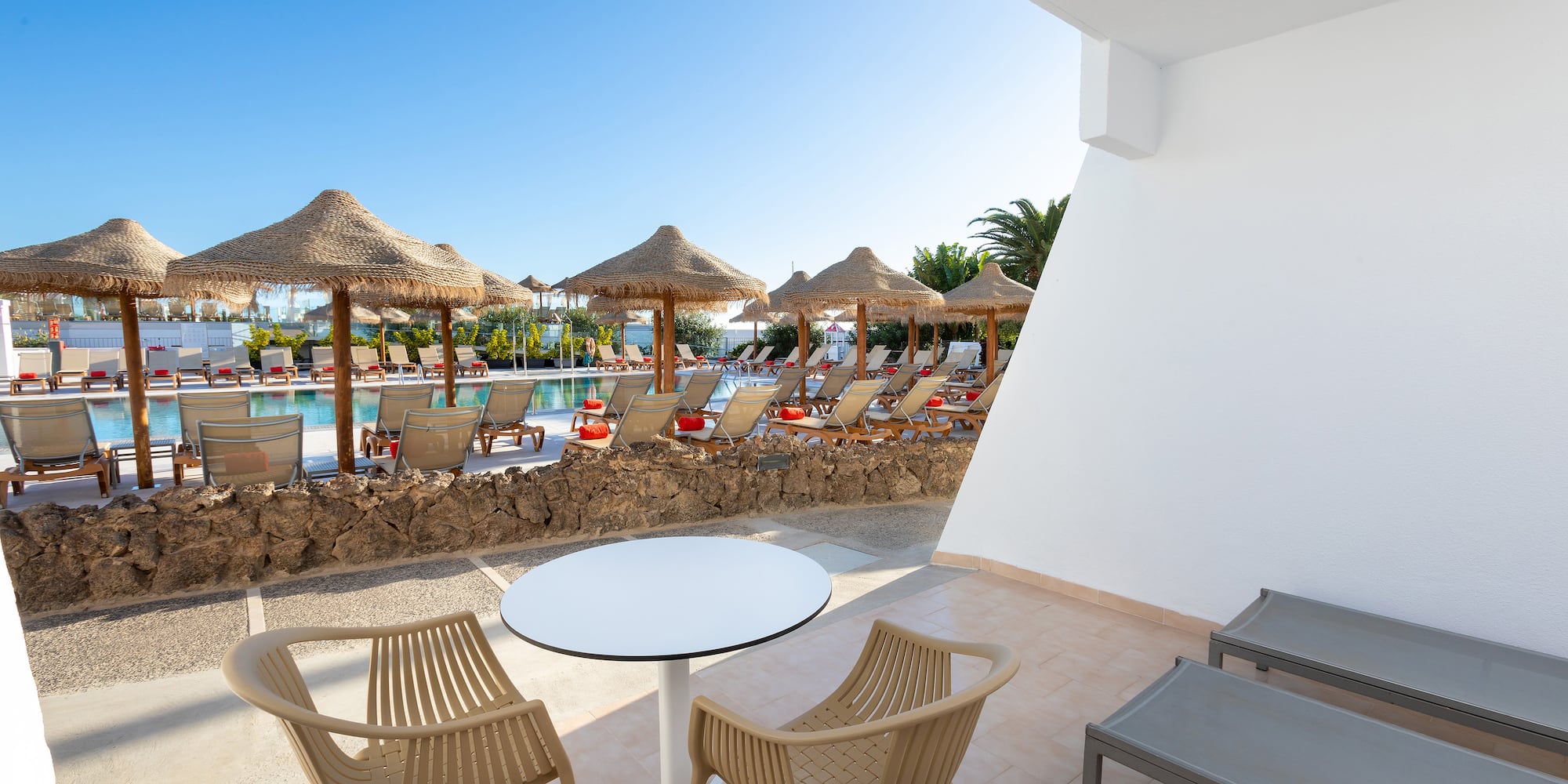 a patio with chairs and umbrellas