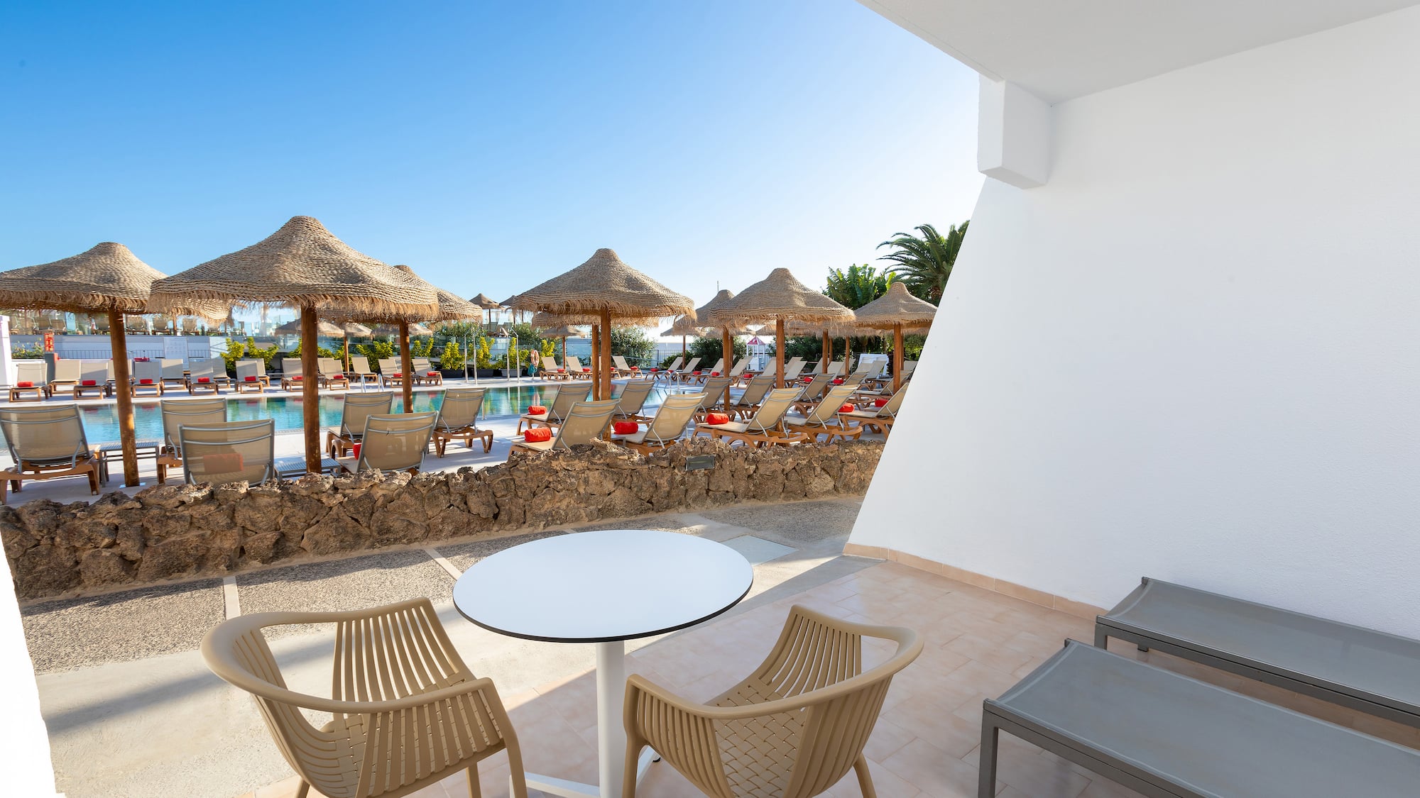 a patio with chairs and umbrellas