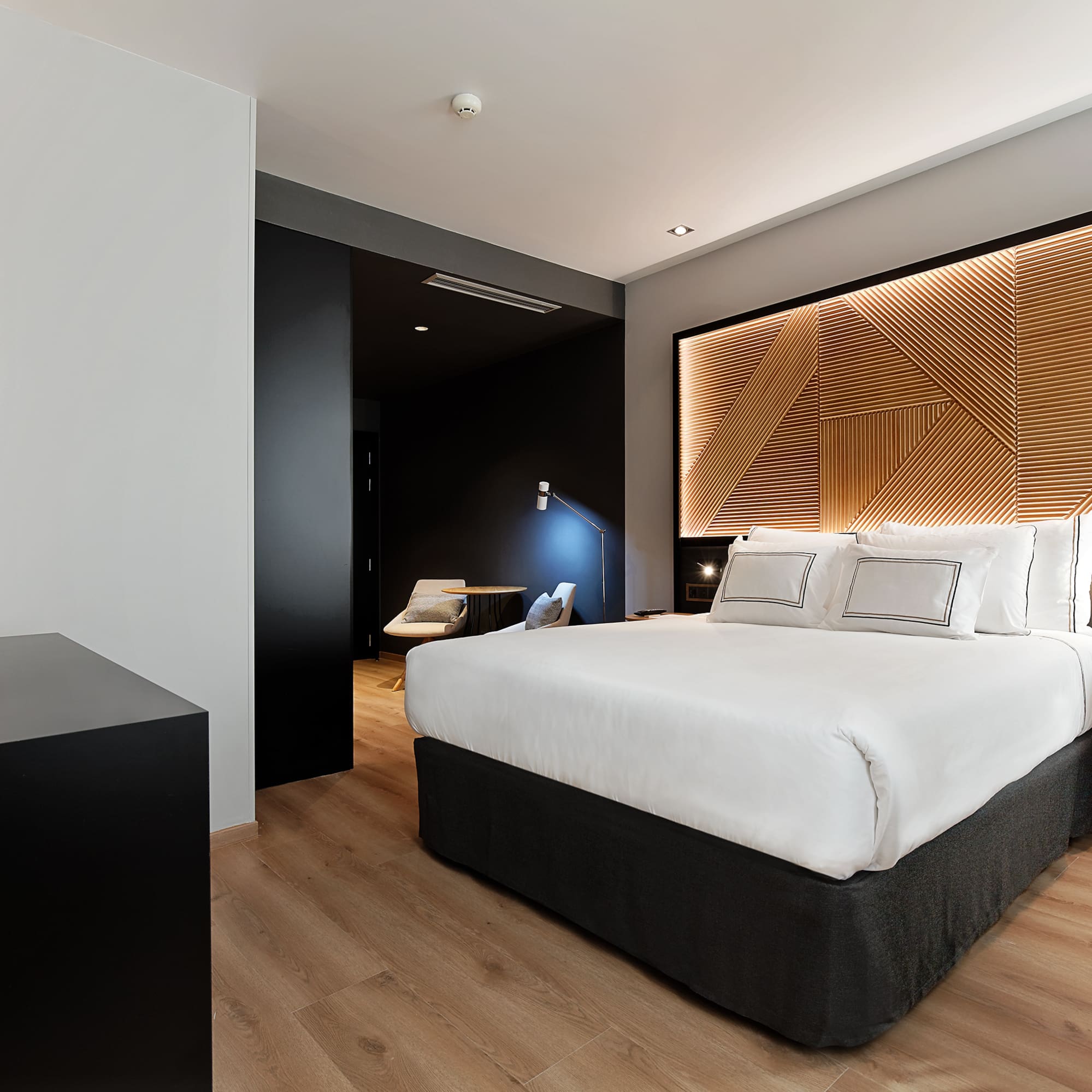 a bedroom with a bed and a wood floor