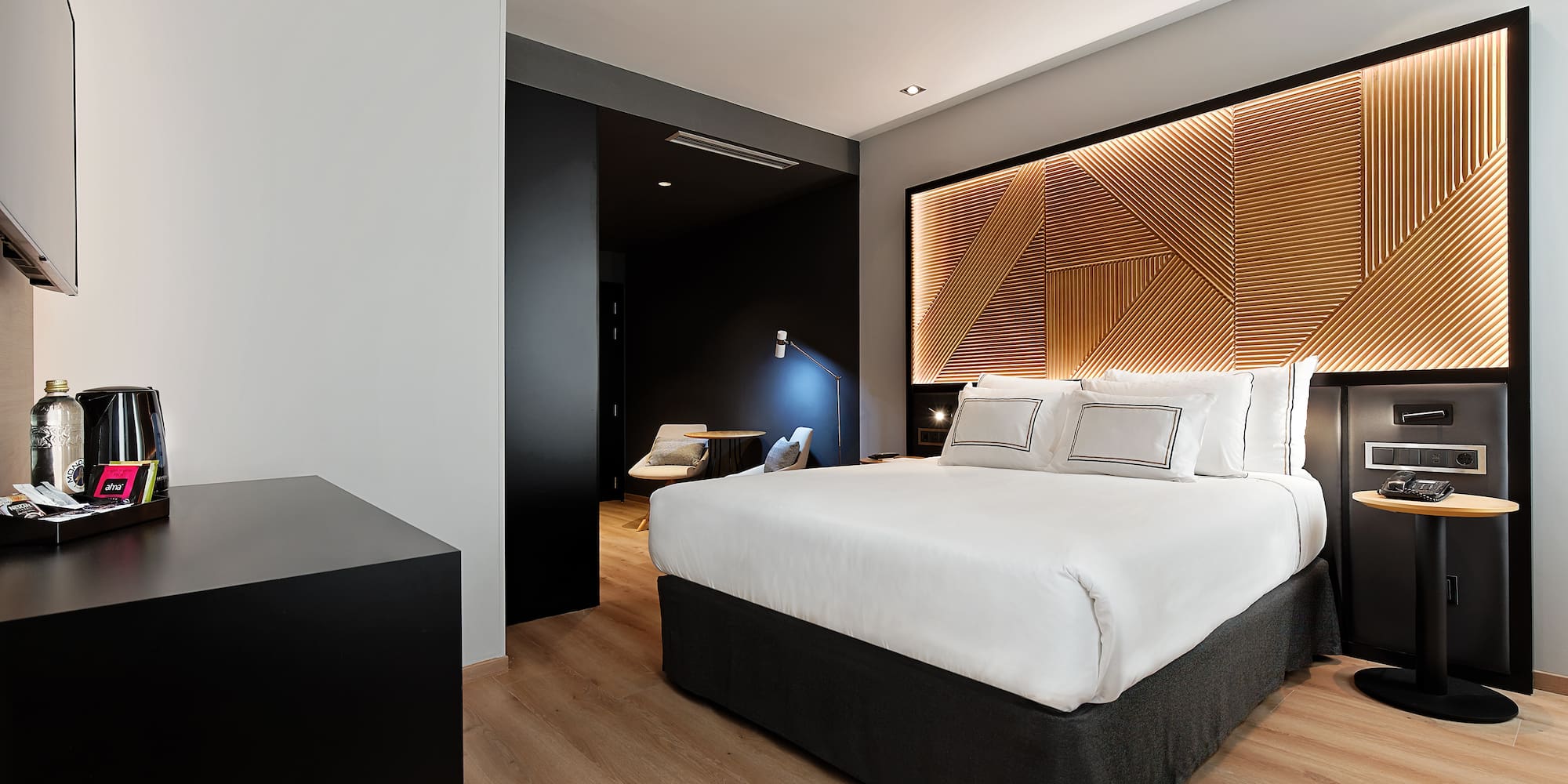 a bedroom with a bed and a wood floor