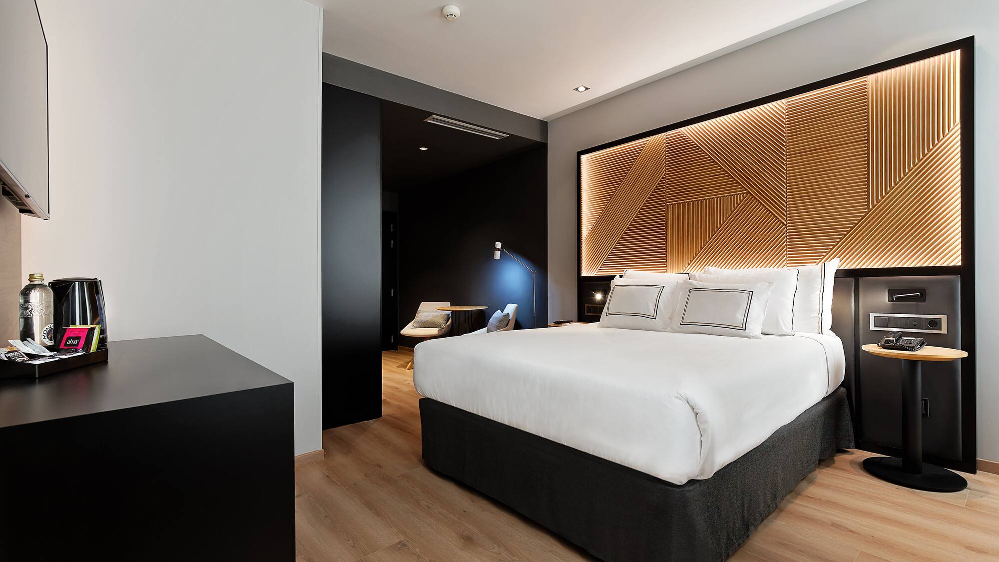 a bedroom with a bed and a wood floor