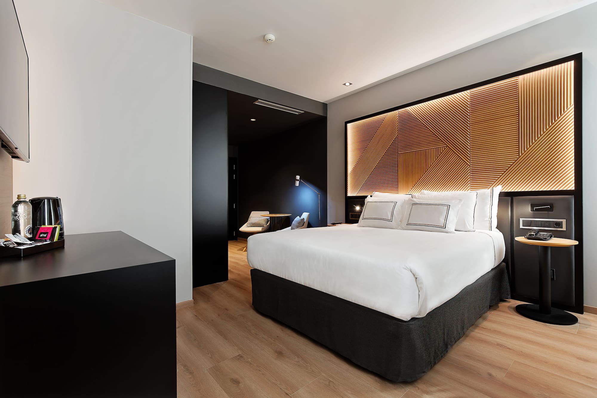 a bedroom with a bed and a wood floor