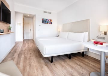 a room with two beds and a wood floor