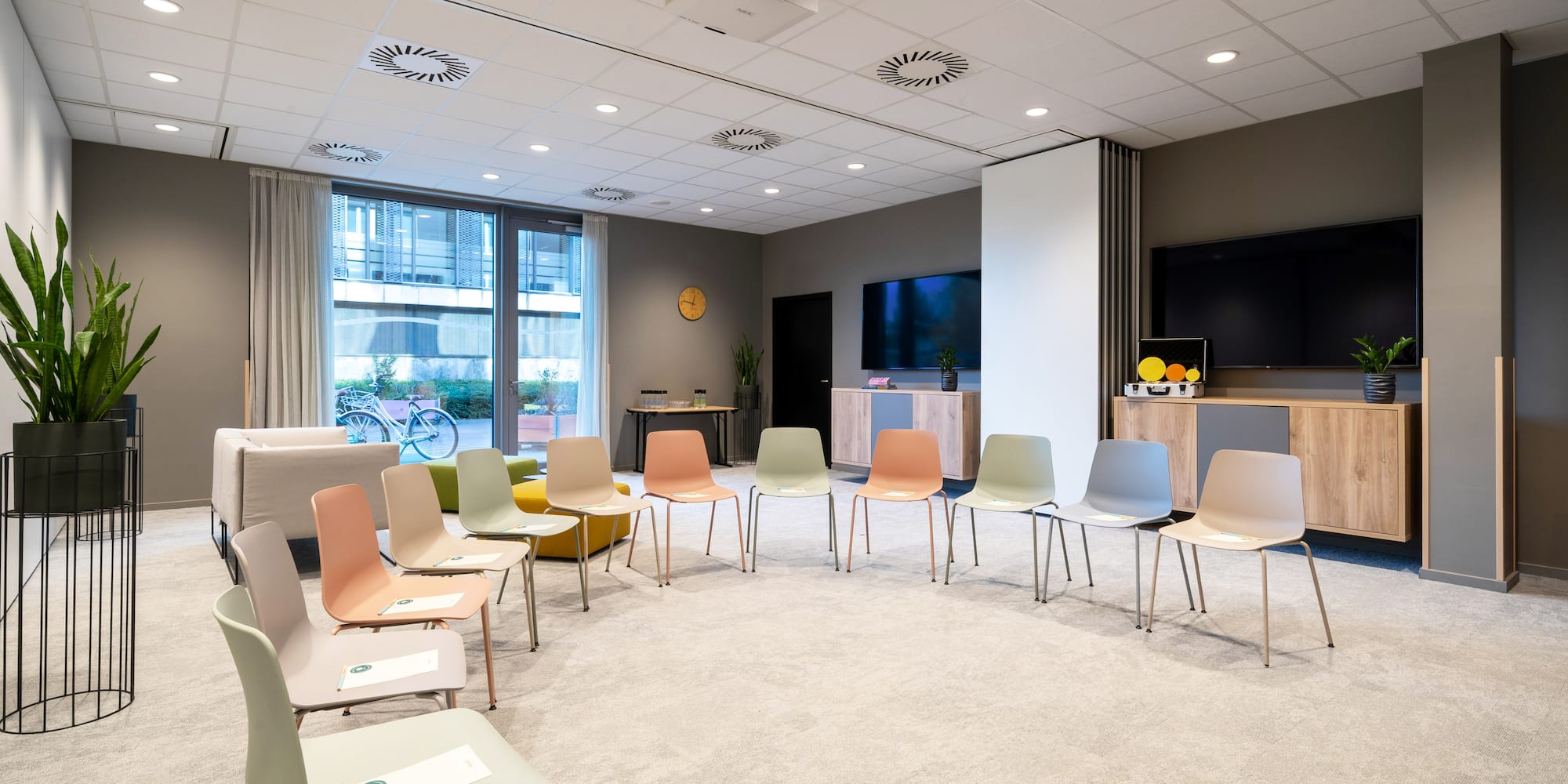 a room with many chairs and a television