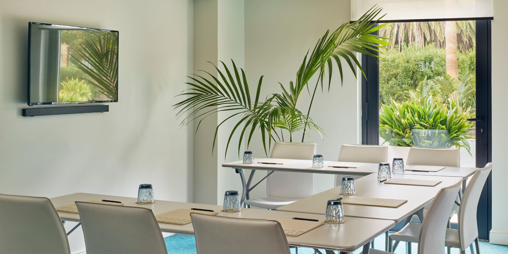 a room with white tables and chairs