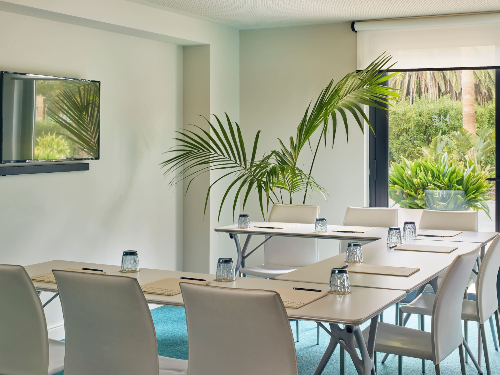 a room with white tables and chairs