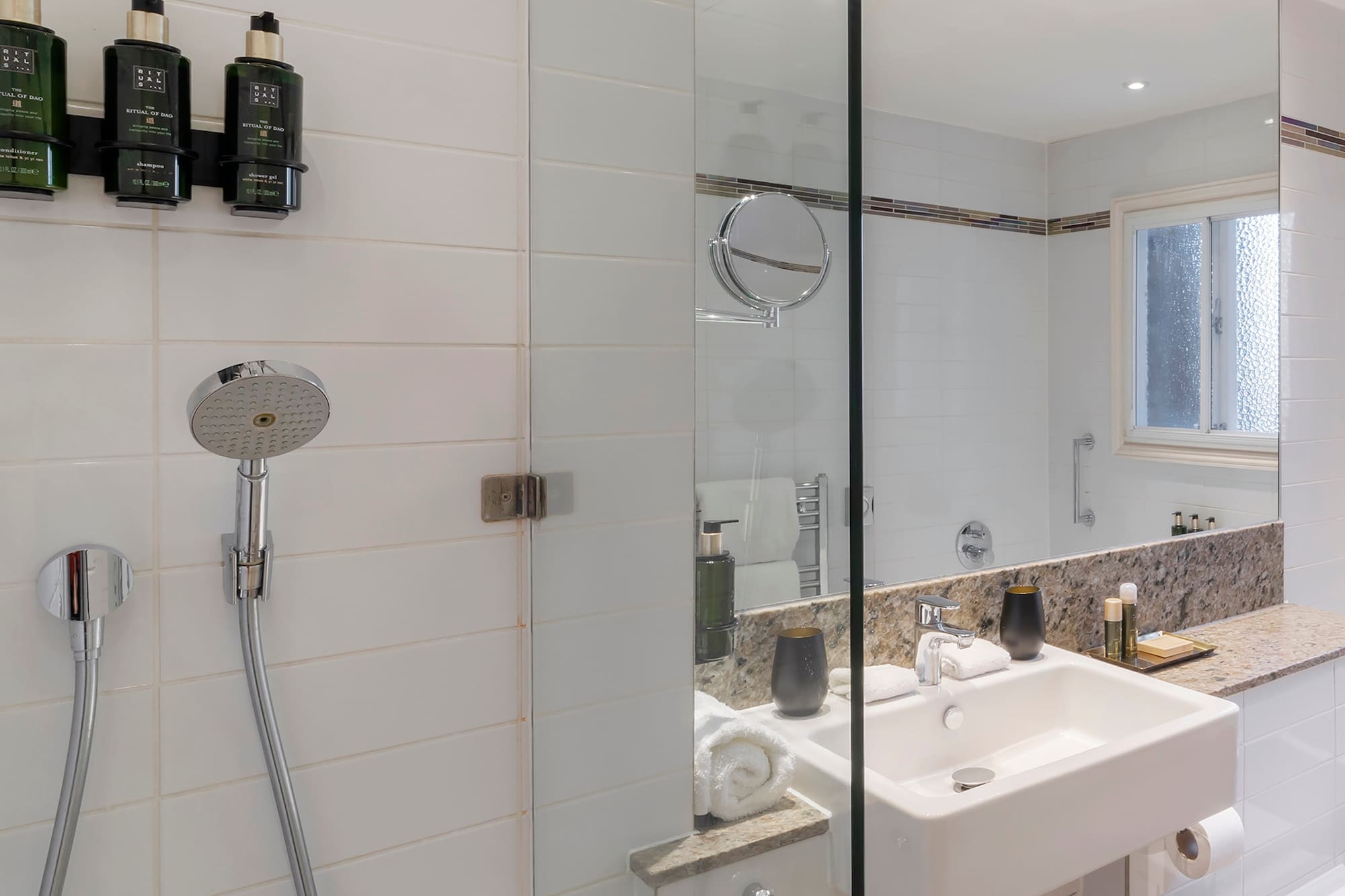 a bathroom with a shower and sink