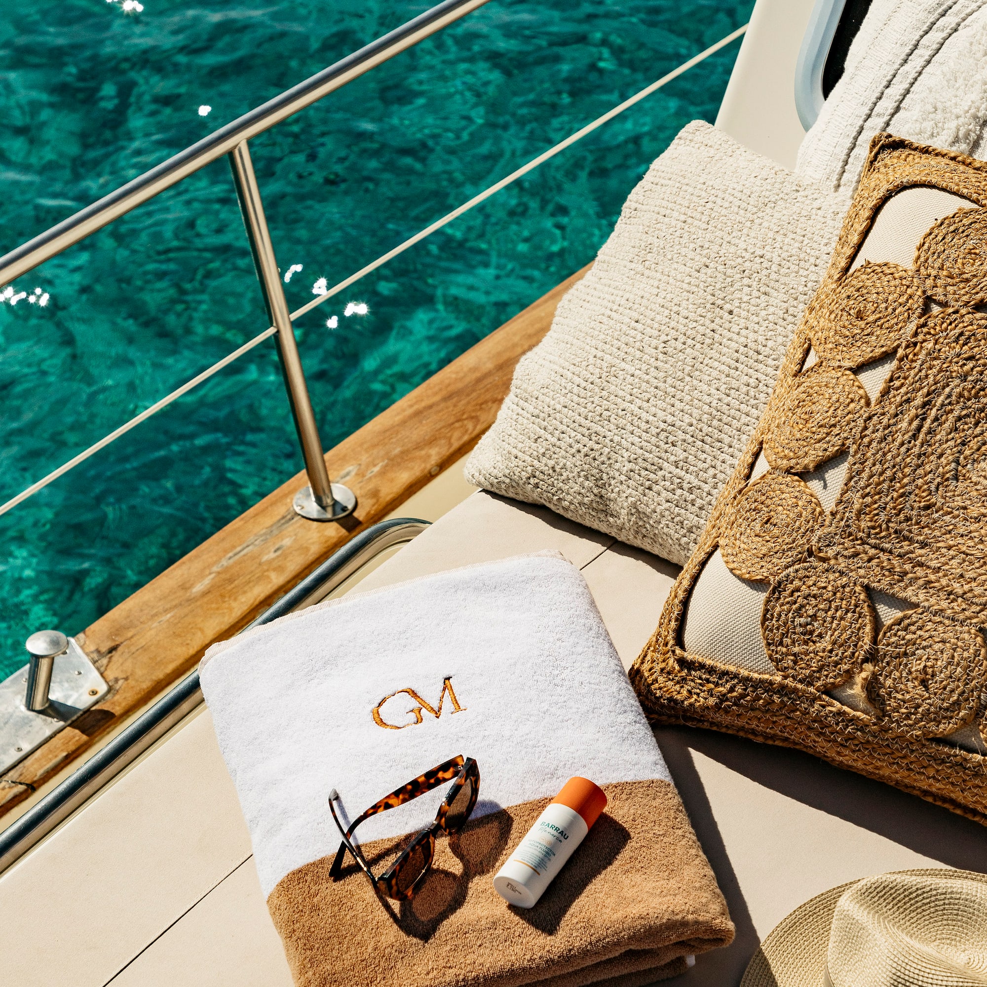 a towel and sunglasses on a boat