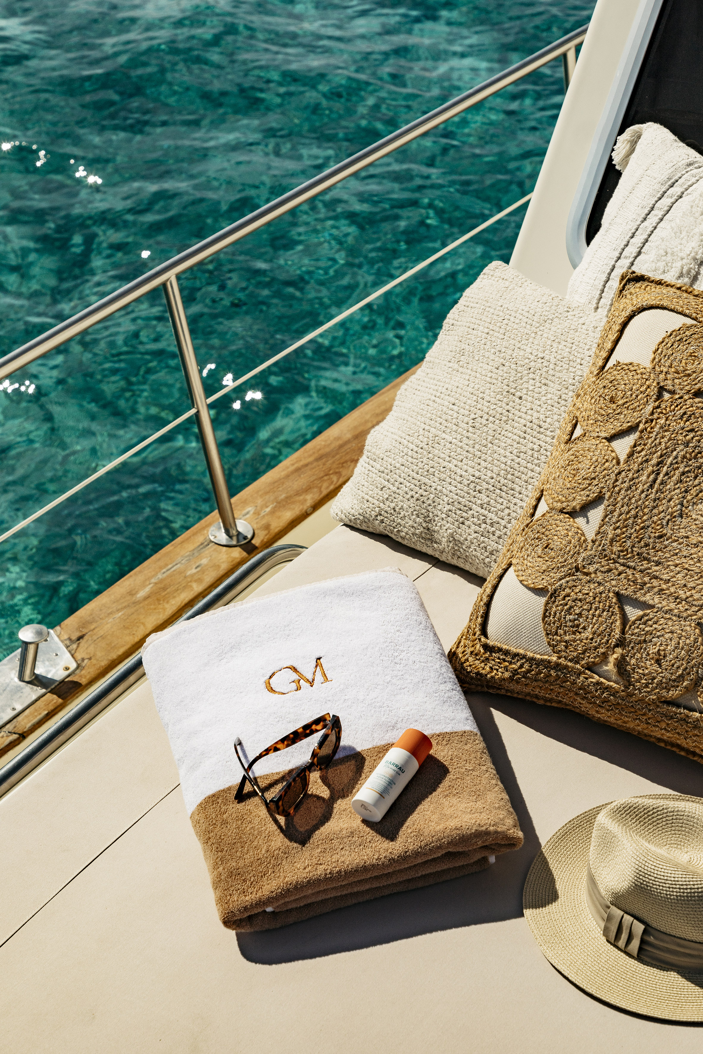 a towel and sunglasses on a boat