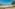 a beach with chairs and a body of water