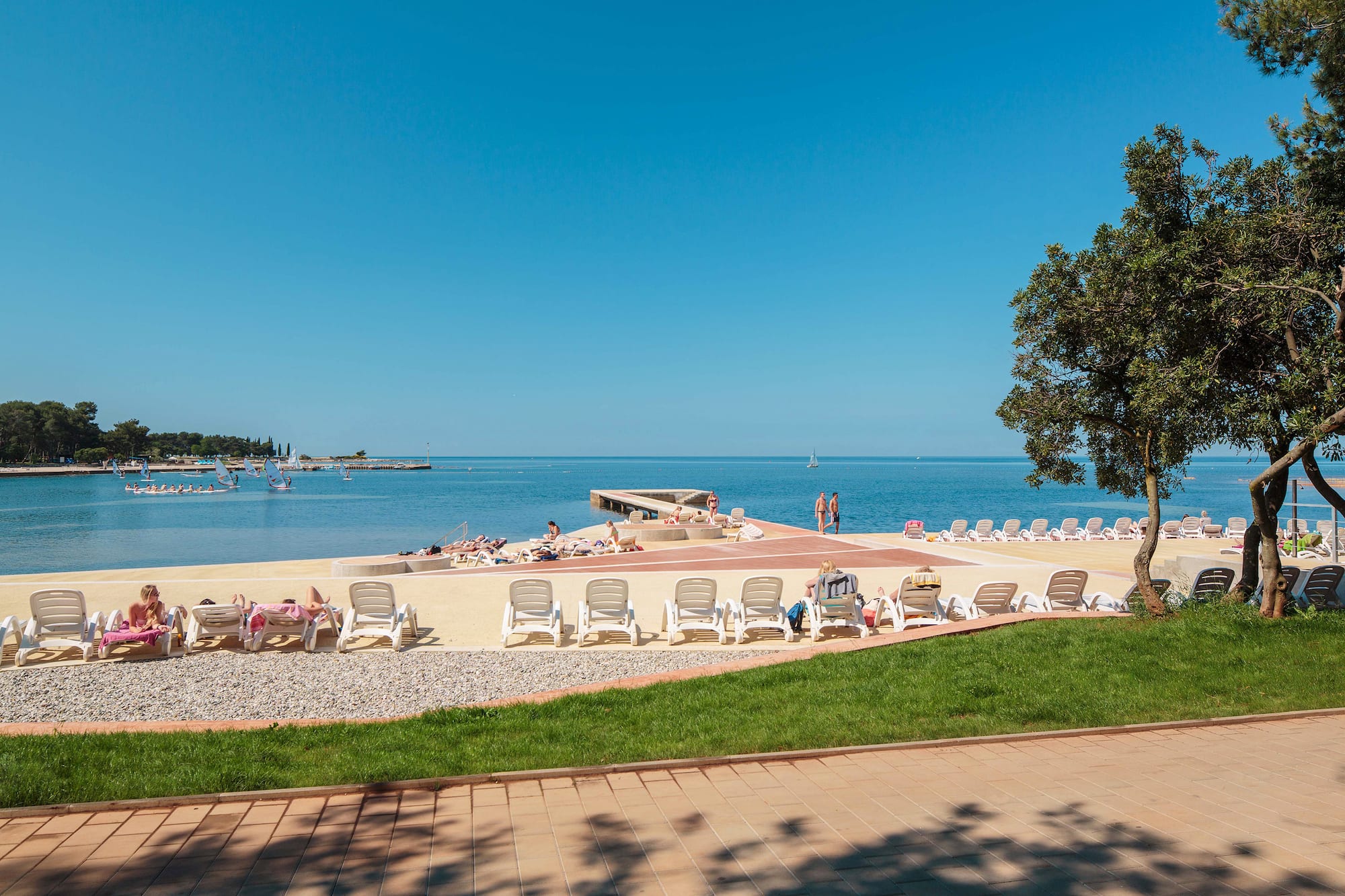 a beach with chairs and a body of water