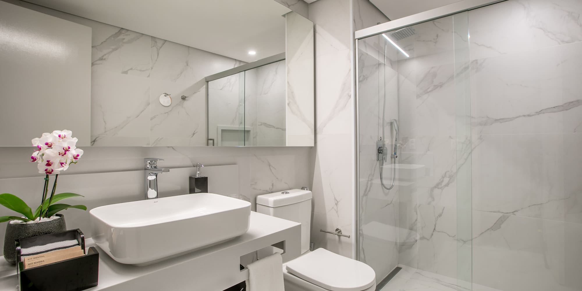 a bathroom with a glass shower and sink