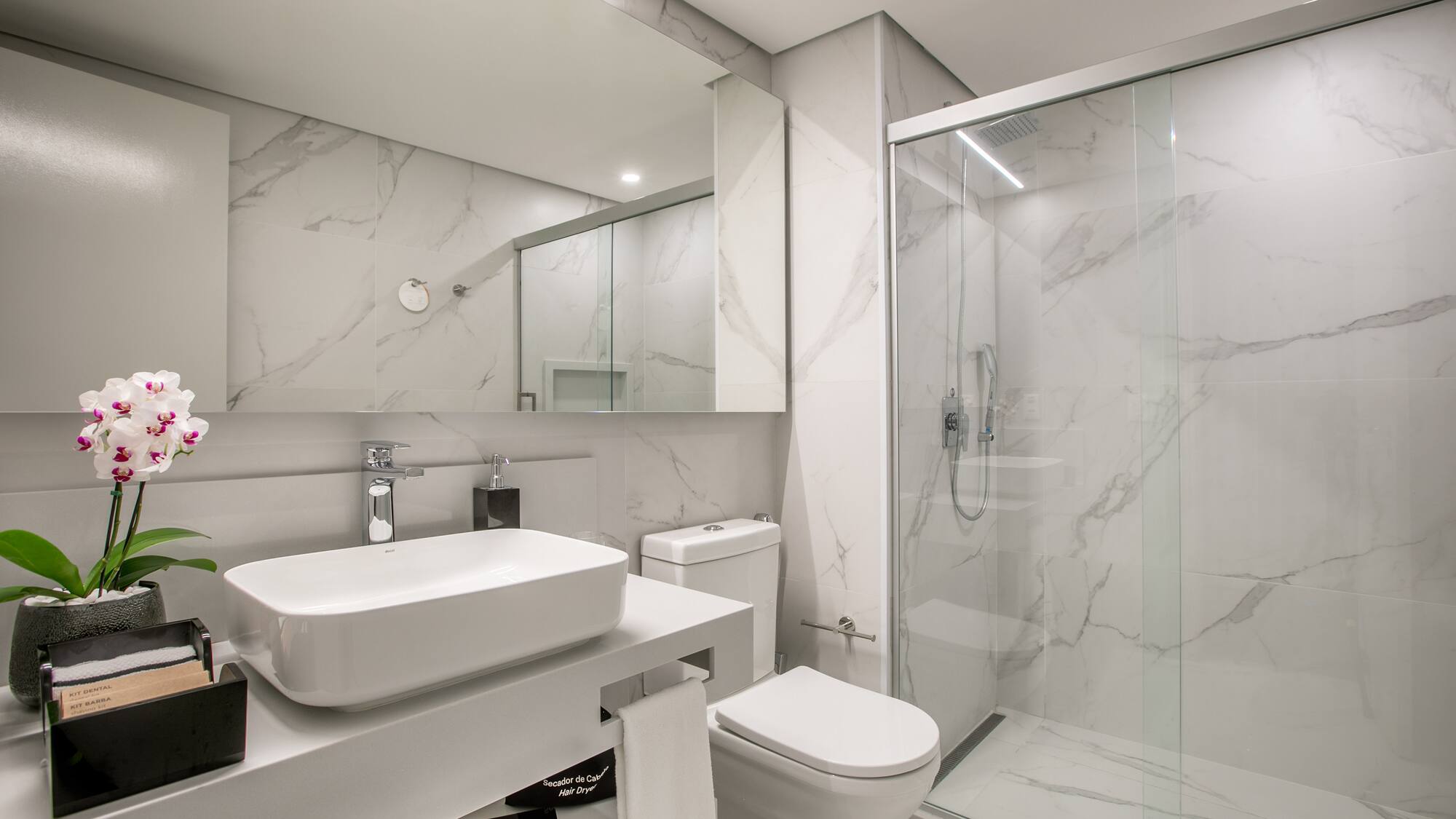 a bathroom with a glass shower and sink