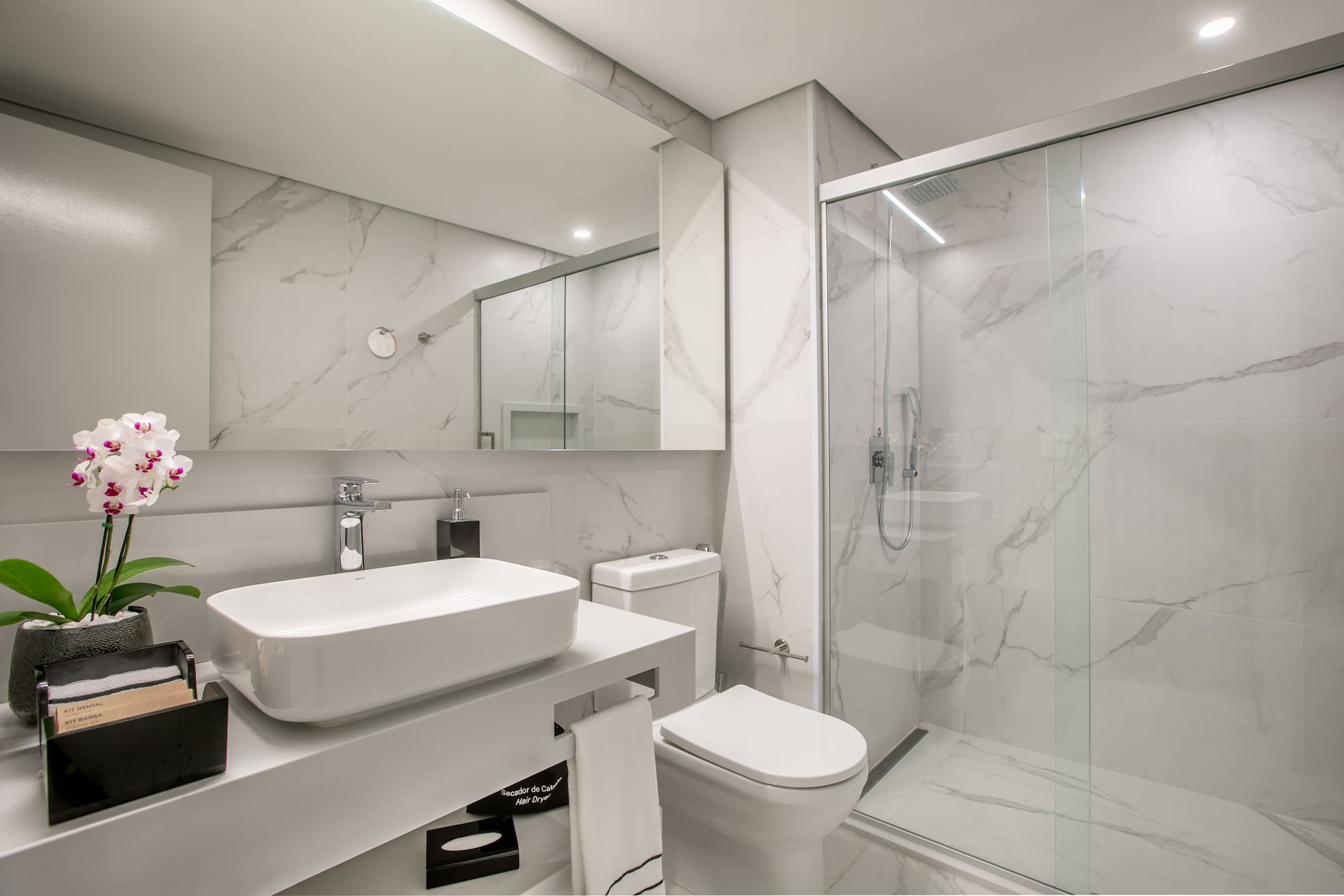 a bathroom with a glass shower and sink