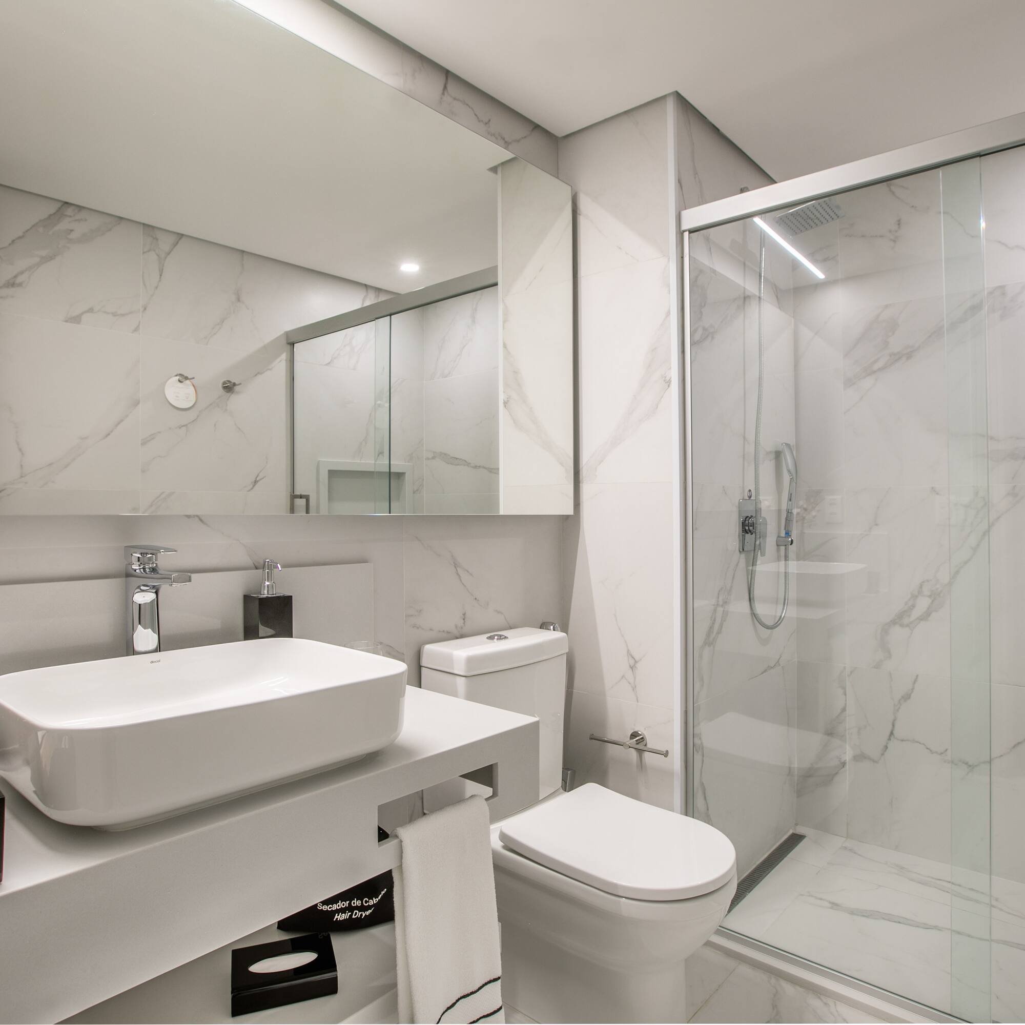 a bathroom with a glass shower and sink