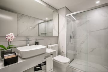 a bathroom with a glass shower and sink
