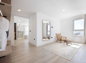 a room with a mirror and a chair