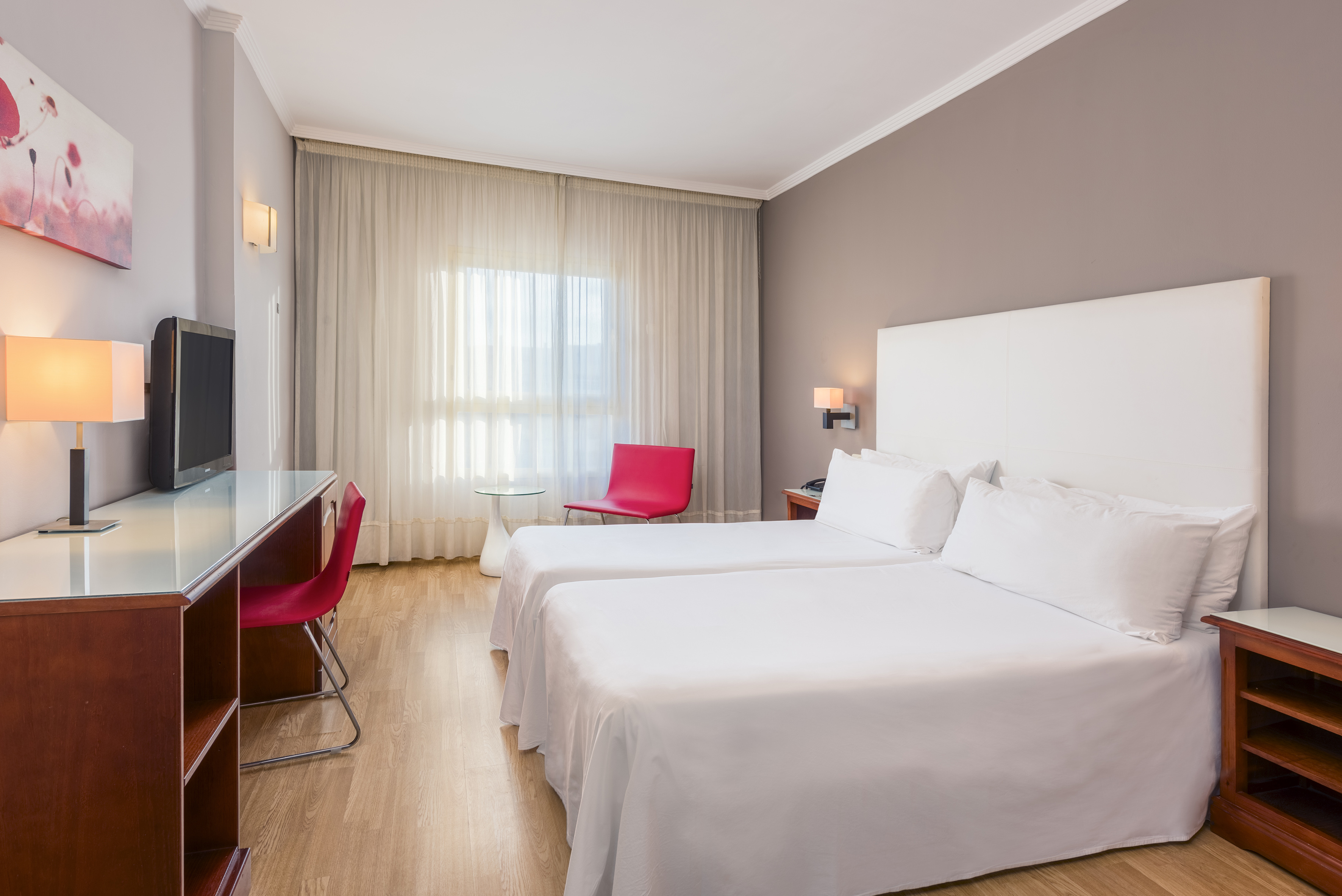 a room with two beds and a desk