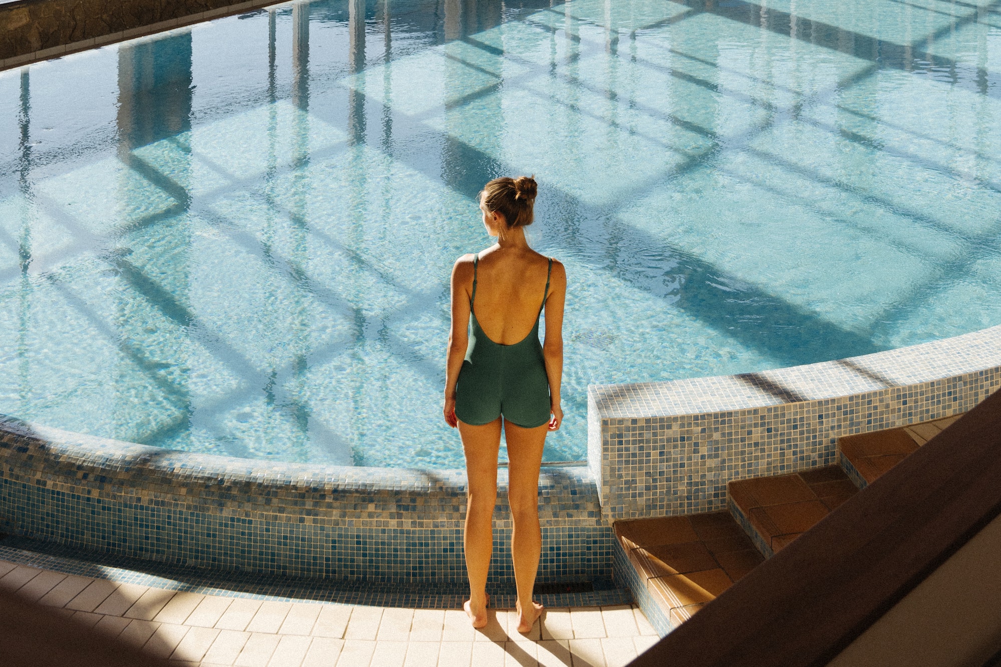 a woman standing in a swimming pool