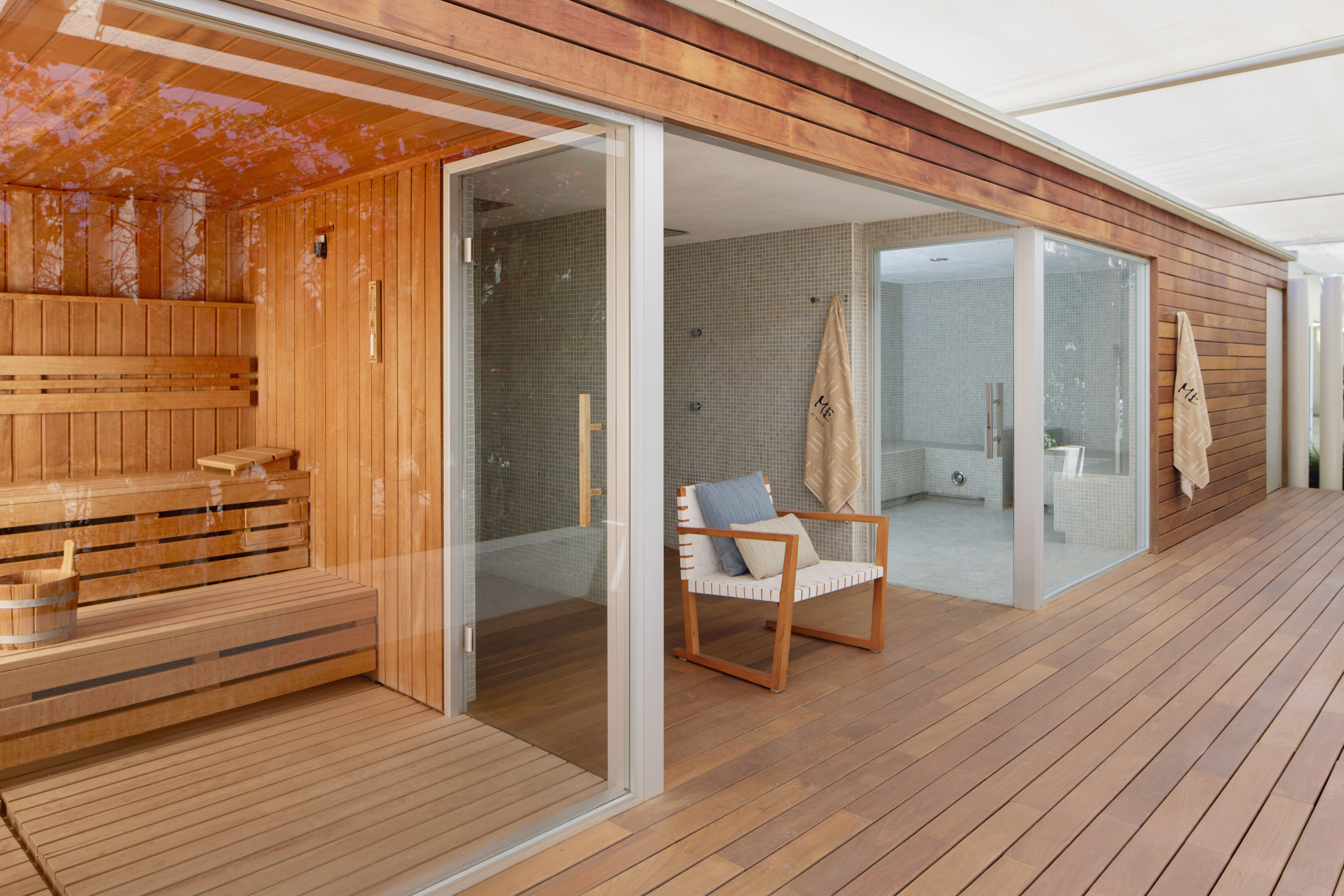 Outdoor wood sauna and steam room with relaxation deck.