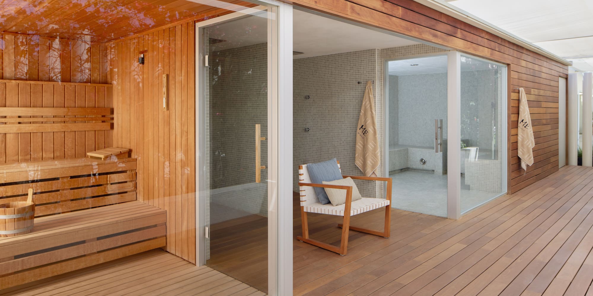 Outdoor wood sauna and steam room with relaxation deck.