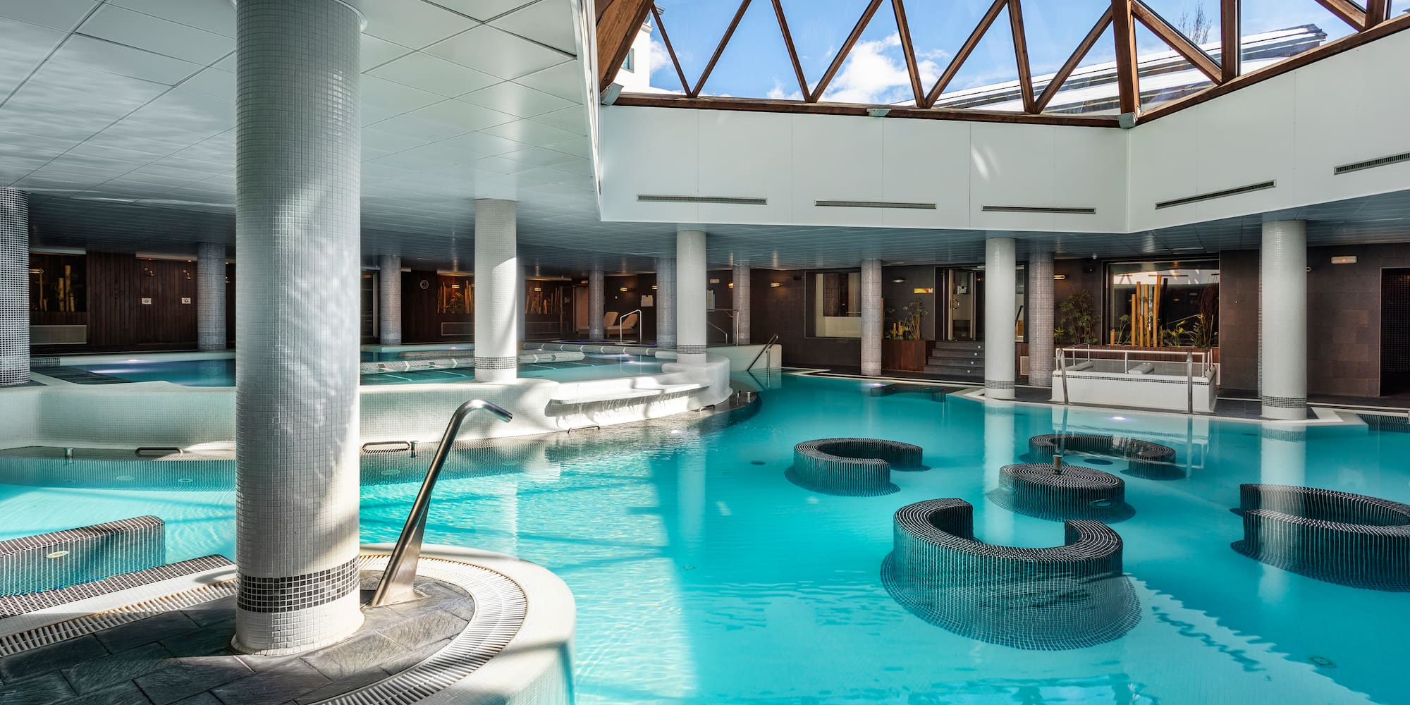 a large indoor pool with a glass roof