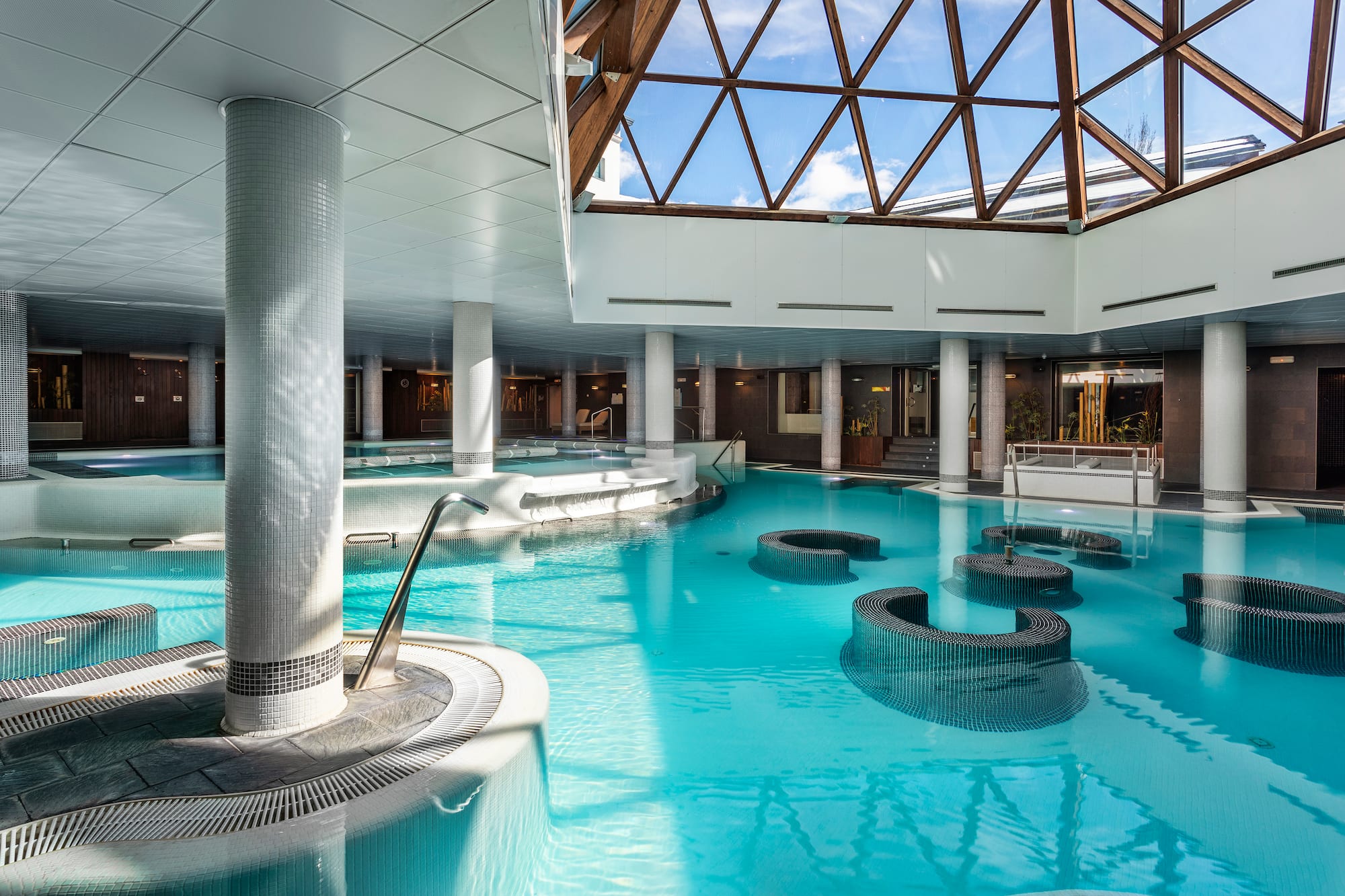 a large indoor pool with a glass roof