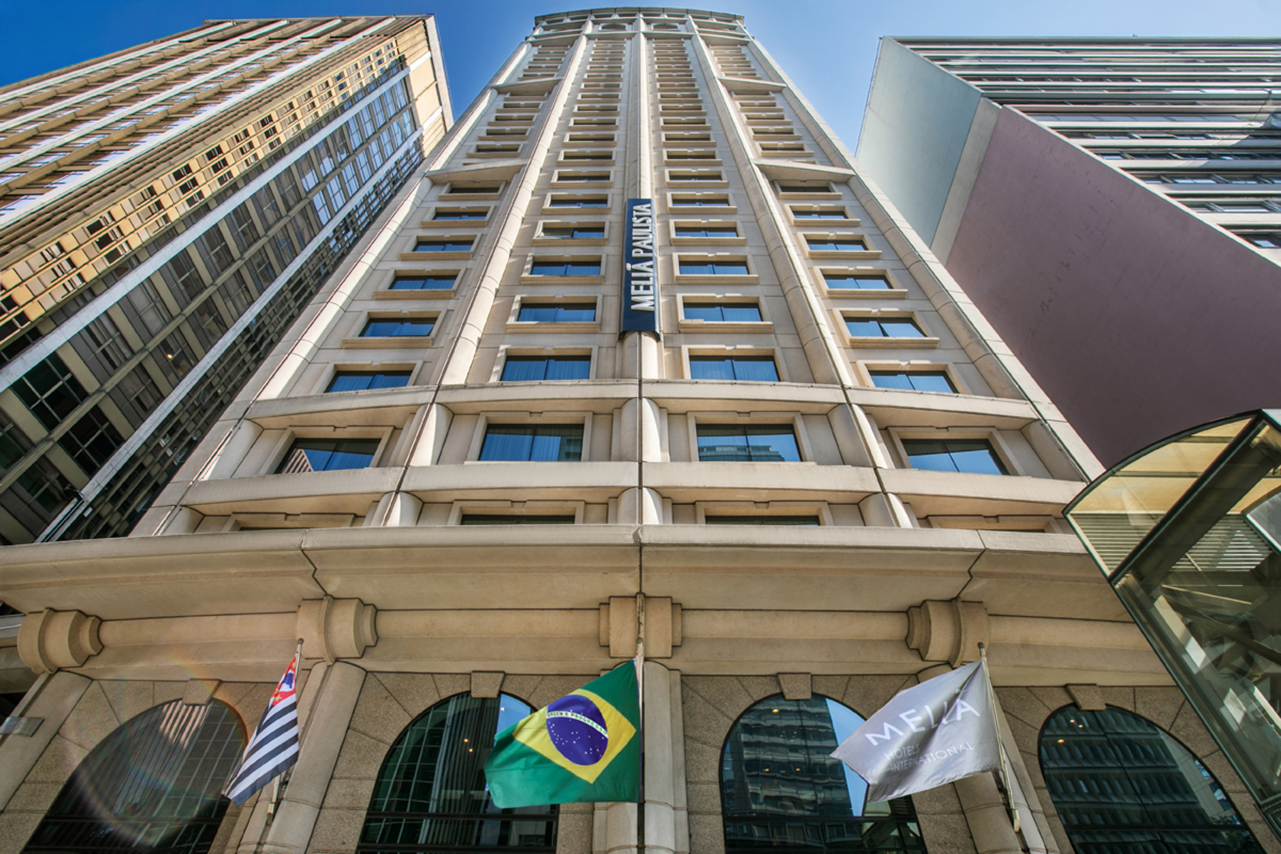 Melia Paulista skyscraper with Brazilian and hotel flags, Sao Paulo.