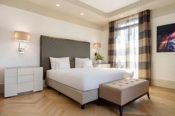 a bed with a bench in a room