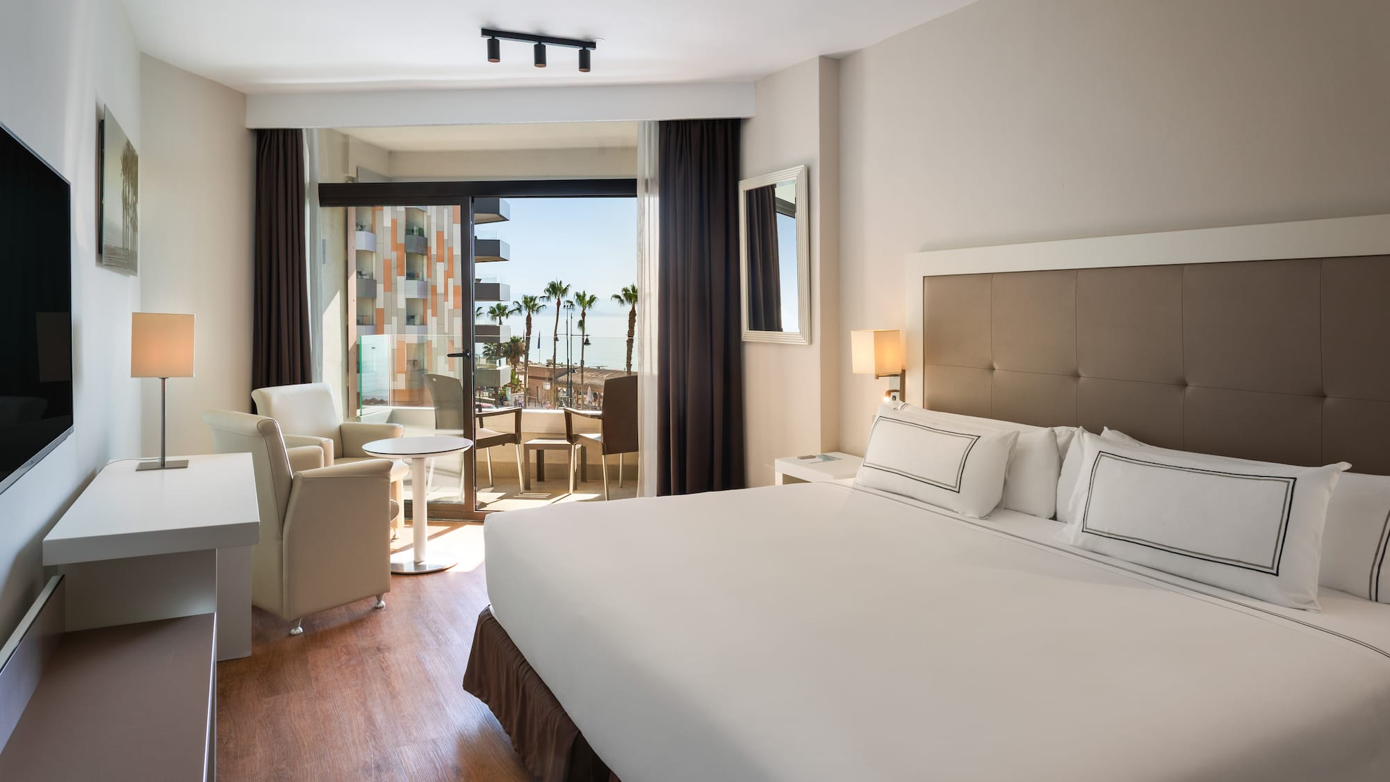 a room with a bed and chairs and a table