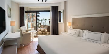 a room with a bed and chairs and a table