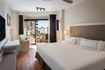 a room with a bed and chairs and a table