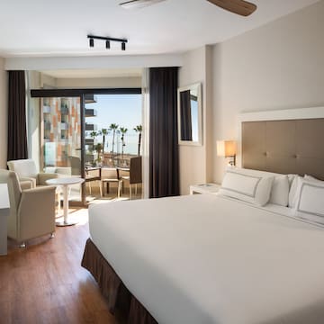 a room with a bed and chairs and a table