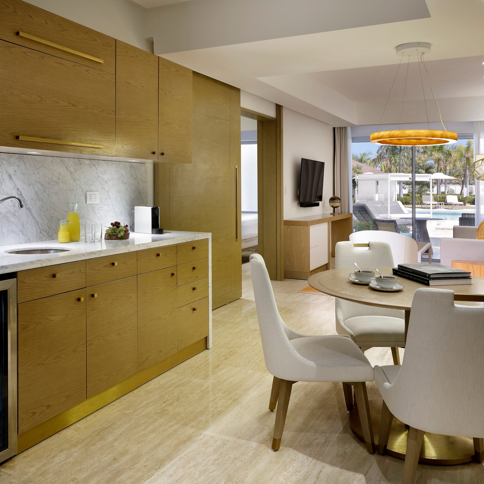 a kitchen and dining room with a table and chairs