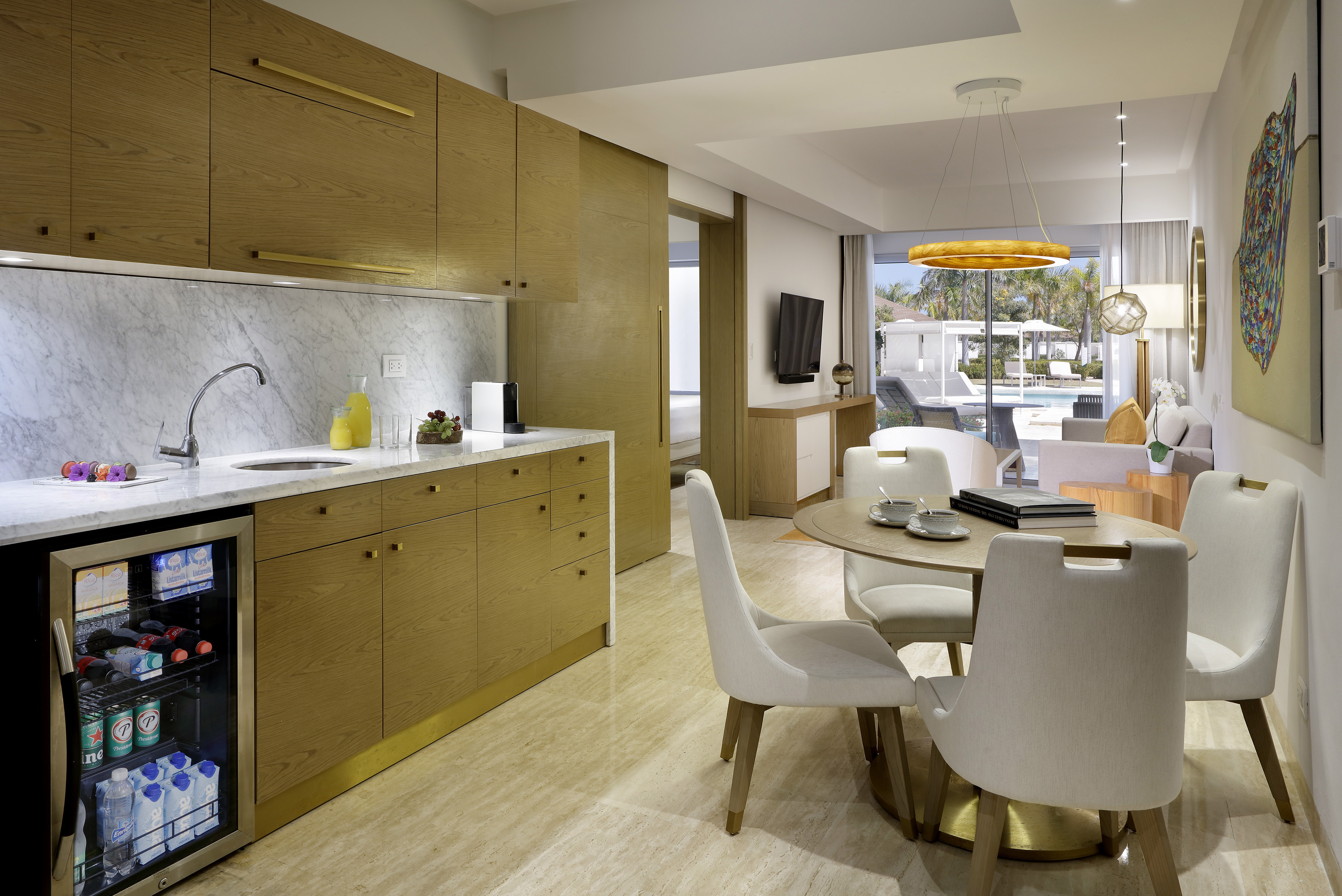 a kitchen and dining room with a table and chairs