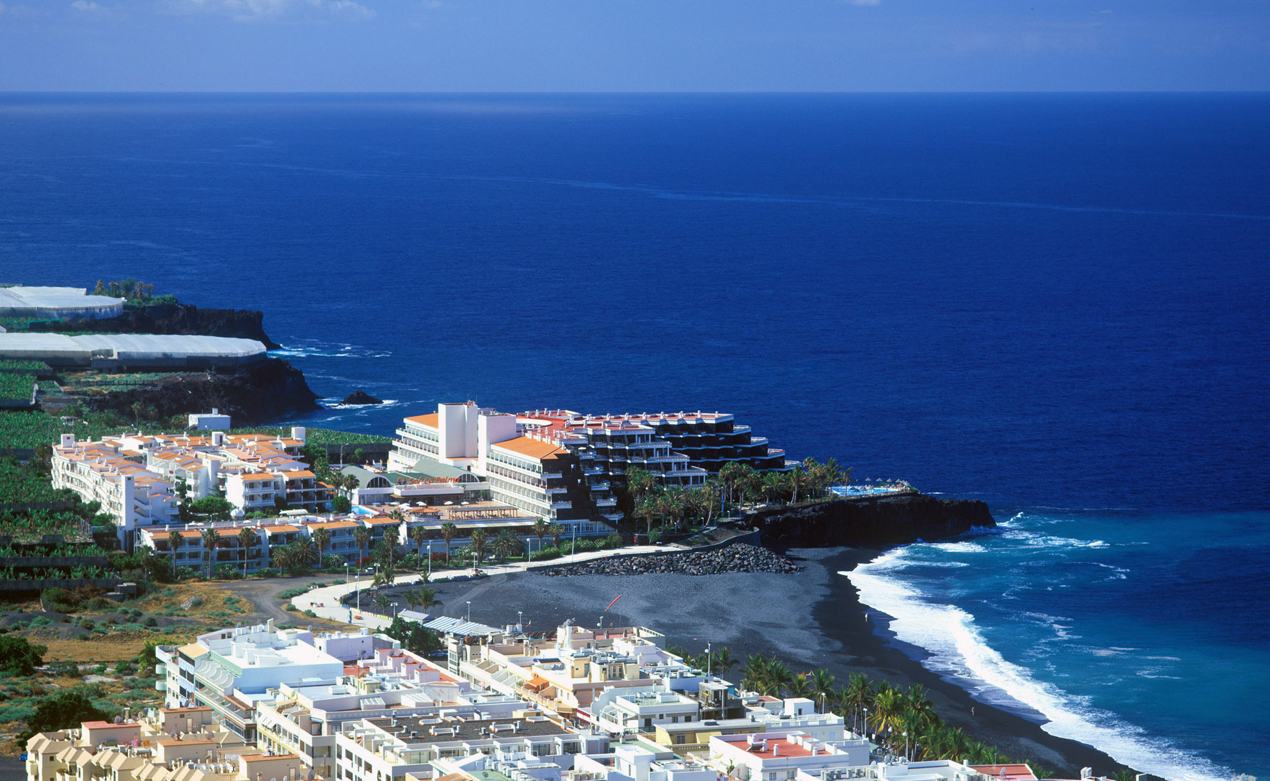 La Palma coastal resort, black sand beach, oceanfront hotel, deep blue sea.
