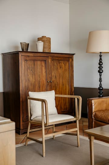 a chair next to a cabinet
