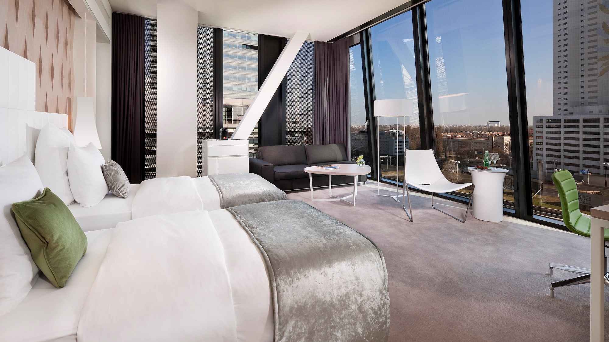 a room with two beds and a couch