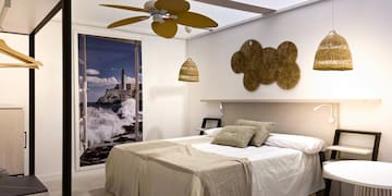 a bedroom with a bed and ceiling fan