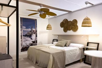 a bedroom with a bed and ceiling fan