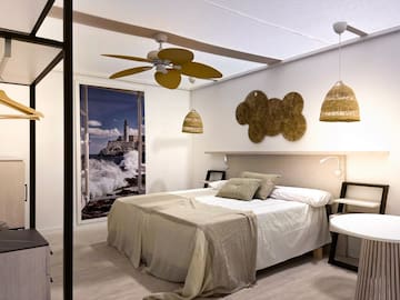a bedroom with a bed and ceiling fan